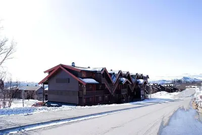 a log cabin in the snow on a street at Central on Beitostølen with walking distance to everything in Beitostøl