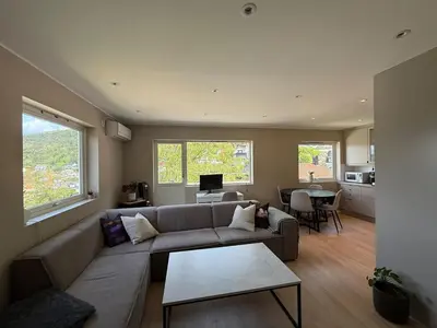 a living room with a couch and a table at Moderne 3-roms nær sentrum in Bergen