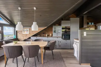 a kitchen with a wooden table and chairs at Fagertoppen 1314B by Vacation Trysil in Trysil