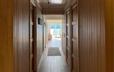 a hallway of a house with a hallwayngthngthngthngthngthngthngthngth at Cozy Apartment In Gurskøy With Sauna in Kjellsund