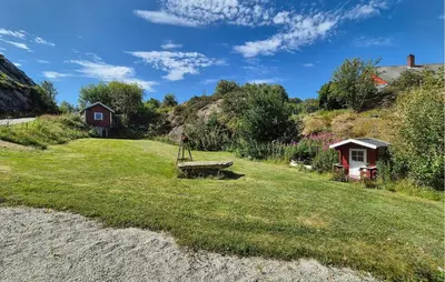 a yard with a bench in the grass at Amazing Home In Rubbestadneset With Wifi in Rubbestadneset