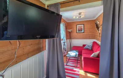 a living room with a large flat screen tv on a wall at Amazing Home In Rubbestadneset With Wifi in Rubbestadneset