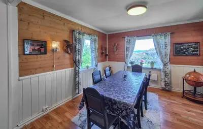 a dining room with a table and chairs and a window at Amazing Home In Rubbestadneset With Wifi in Rubbestadneset