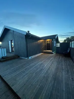 a house with a large wooden deck at Stort hus i Steinkjer in Steinkjer