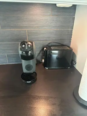 a coffee maker and a toaster sitting on a counter at Flott bolig på Øvre kleppe med fine solforhold og fin uteplass in Askøy