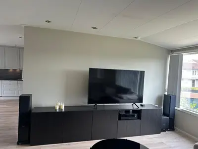 a living room with a flat screen tv on a wall at Flott bolig på Øvre kleppe med fine solforhold og fin uteplass in Askøy