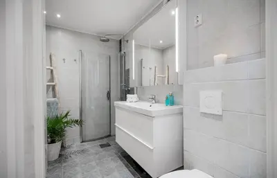 a white bathroom with a sink and a toilet at Flott bolig på Øvre kleppe med fine solforhold og fin uteplass in Askøy
