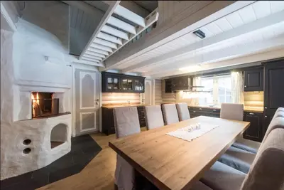 a kitchen with a wooden table and an oven at Tveitehaug cabin, 3-4 bedroom cabin close to ski center in Ål