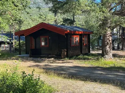a small wooden cabin with a red roof at Bjorliheimen Fjellhotell-Hytte 6 in Bjorli
