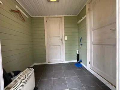 a room with green walls and a door and a floor at Bjorliheimen Fjellhotell-Hytte 6 in Bjorli