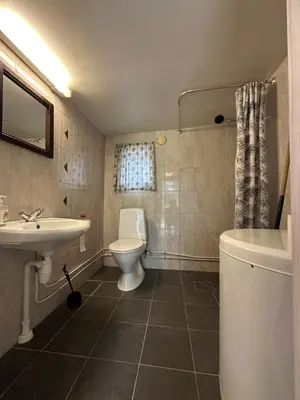 a bathroom with a sink and a toilet and a tub at Bjorliheimen Fjellhotell-Hytte 6 in Bjorli