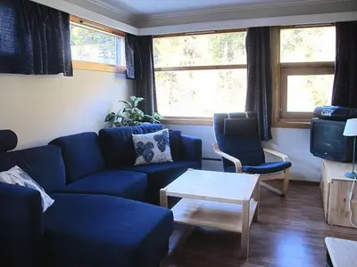 a living room with a blue couch and a table at Actif 413 - apartment close to Ål Ski Centre in Ål