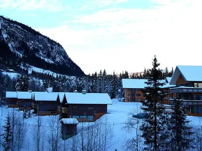 a ski lodge with snow on the ground next to a mountain at Actif 413 - apartment close to Ål Ski Centre in Ål