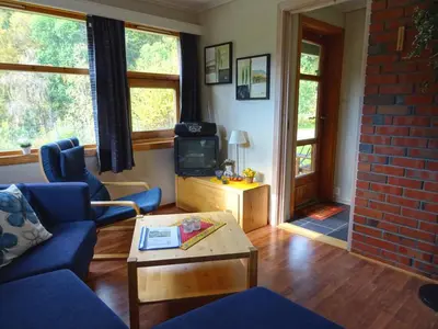 a living room with a blue couch and a tv at Actif 413 - apartment close to Ål Ski Centre in Ål