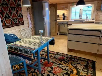 a kitchen with a table in the middle of a room at Log Cabin With Panoramic Views Of Hallingskarvet in Holo