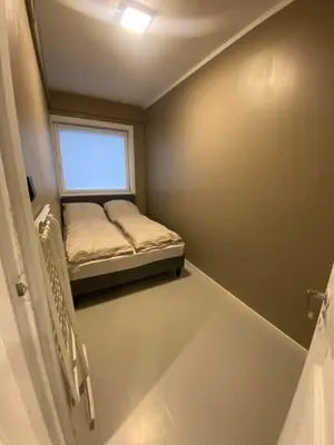 a small room with a bed and a window at Dronningens Gate 95, H0301 in Lii