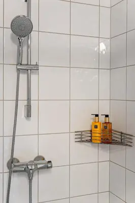 a bathroom with a shower with white tiles at Fagerasen 790D by Vacation Trysil in Trysil