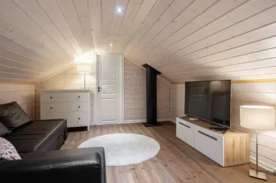 a living room with a couch and a flat screen tv at Solsiden 16B by Vacation Trysil in Trysil