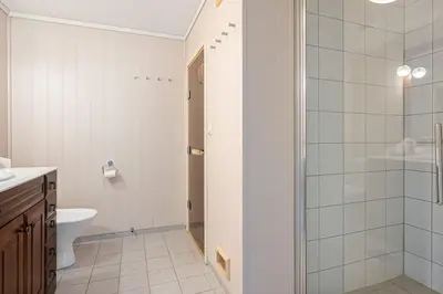a white bathroom with a toilet and a shower at Fagerasen 760B by Vacation Trysil in Trysil