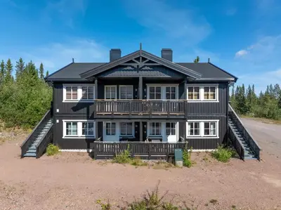 a large black house with a balcony at Fagerasen 760B by Vacation Trysil in Trysil