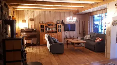 a living room with a couch and a table at Gemütliche Ferienwohnung am Fjord