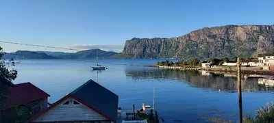 a large body of water with a boat in it at Gemütliche Ferienwohnung am Fjord