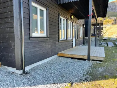 a porch of a house with a wooden deck at Ferieleilighet i Tråstølen in Vossevangen