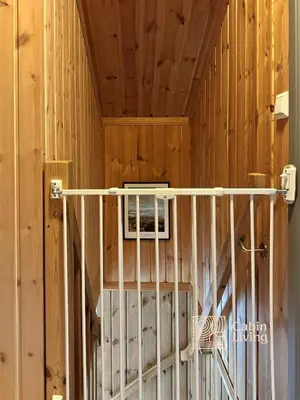 a room with a crib in a wooden wall at Modern cabin sauna, BBQ & beautiful view Filefjell in Tyinkrysset