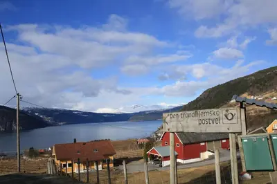 a sign that reads not traumatizing doubt next to a lake at Panorama by the fjord - Stryn in Stryn
