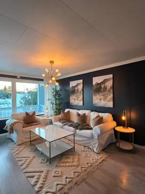 a living room with a couch and a table at Nyoppusset leilighet nær Aker og sentrum in Stord