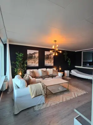 a living room with a couch and a table at Nyoppusset leilighet nær Aker og sentrum in Stord