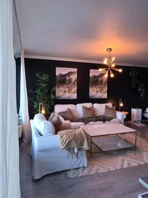 a living room with a white couch and a table at Nyoppusset leilighet nær Aker og sentrum in Stord