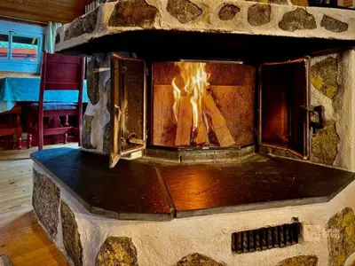 a stone oven with a fire inside of it at Beitostølen Cabin - Sauna, large terrace and BBQ in Beitostøl