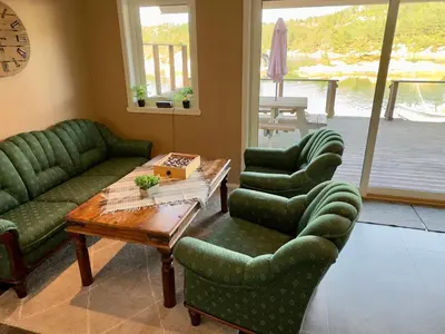 a living room with green couches and a table at 8 person holiday home in Urangsvåg in Ervik