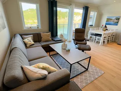 a living room with a couch and a table at 8 person holiday home in Urangsvåg in Ervik