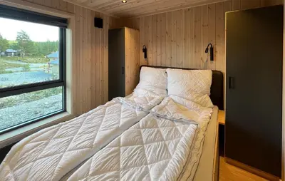 a bed in the corner of a room with a window at Awesome Home In Gålå With Sauna in Gålå