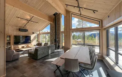 a large living room with a table and a couch at Awesome Home In Gålå With Sauna in Gålå