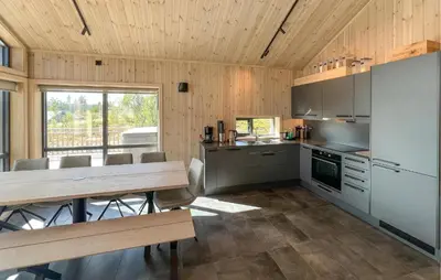 a kitchen with a long table and a dining room at Awesome Home In Gålå With Sauna in Gålå