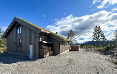 a black building with a grass roof on top of it at Awesome Home In Gålå With Sauna in Gålå
