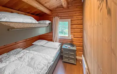 a bedroom with two bunk beds in a log cabin at 4 Bedroom Cozy Home In Nordberg in Nordberg
