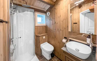 a bathroom with a toilet and a sink and a shower at 4 Bedroom Cozy Home In Nordberg in Nordberg