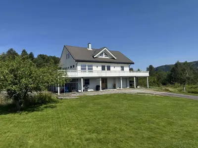 a large white house with a large yard at Korssundvegen 230 in Korssund