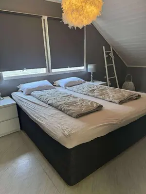a large bed in a bedroom with a large at Korssundvegen 230 in Korssund
