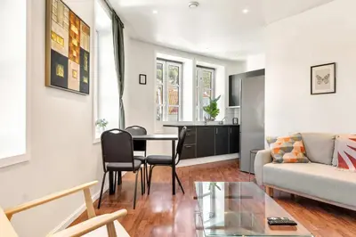 a living room with a table and a couch at Harbour - 1BR Apartment in Bergen