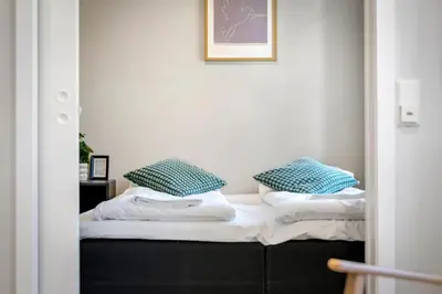 a room with a bed with two pillows on it at Harbour - 1BR Apartment in Bergen