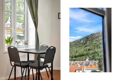 a dining room with a table and a window at Harbour - 1BR Apartment in Bergen