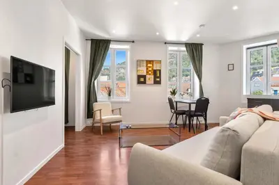 a living room with a couch and a table at Harbour - 1BR Apartment in Bergen