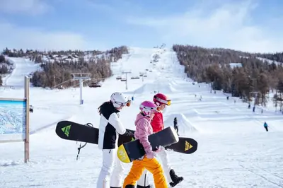 a group of people carrying snowboards on a ski slope at Skogsbu - Stylish, Close to Ski centers and hiking trails in Nesbyen