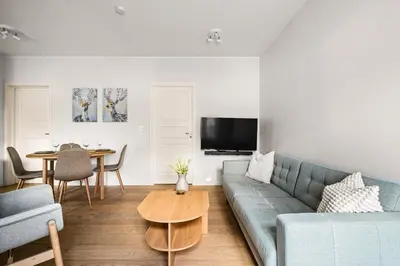a living room with a couch and a table at Light & Modern, City Apartment in Bergen