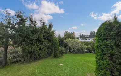 a yard with trees and a house in the background at Lovely Home In Hamar With Wifi in Hamar